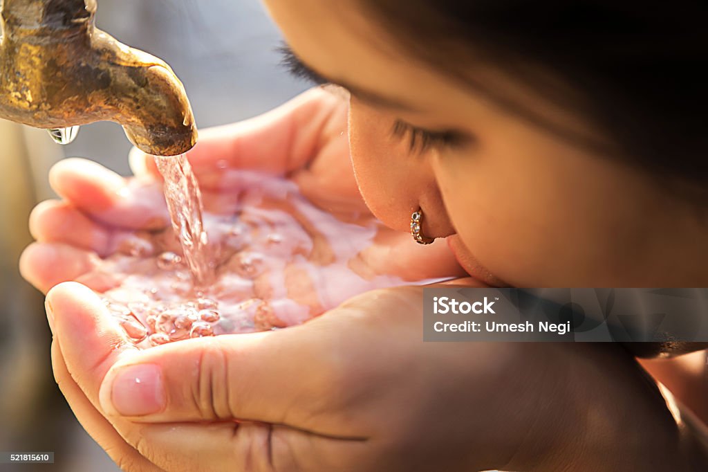 GIRL DRINKING WATER FROM TAP